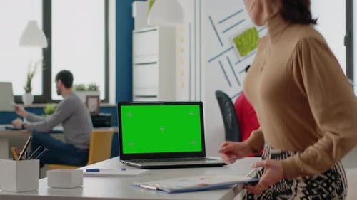 Person Working with Green Screen on Laptop