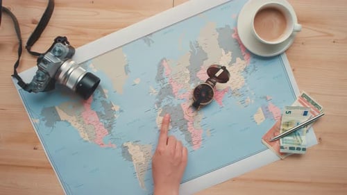 Hand Points to Locations on World Map