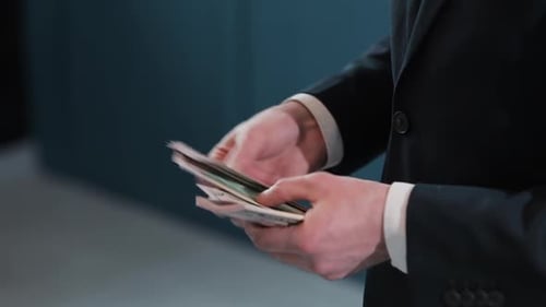 Businessman Counting Dollar Banknotes, A Business Deal with the Transfer of Money, Close-up of Man