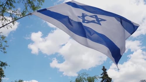 Israeli Flag Waving Against Blue Sky