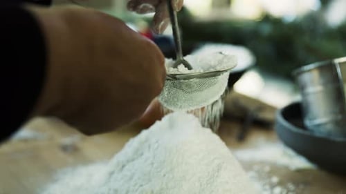 Sifting Flour Through Metal Sieve for Baking