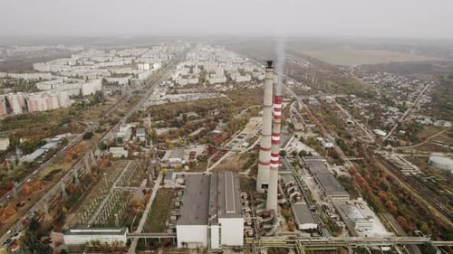 Aerial View of the High Pipes of the Thermal Power Plant Near the Modern City