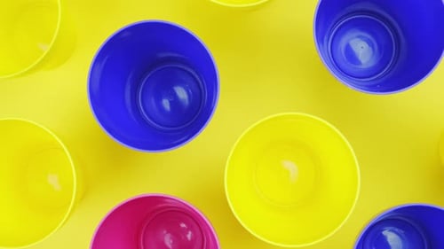 top view color plastic cup on yellow background