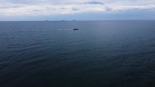 Drone view. flight over the black sea. sunny weather. small boat goes by sea