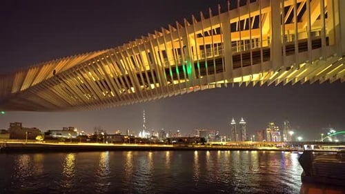 Twisted Bridge. Structure of architecture with lake or river, Dubai Downtown skyline