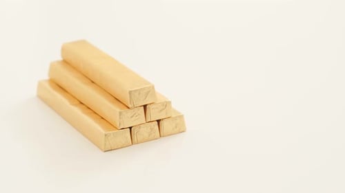 Golden Chocolate Bars Stacked on a White Surface