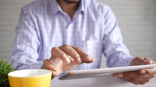 Businessman Using Digital Tablet on Office Desk