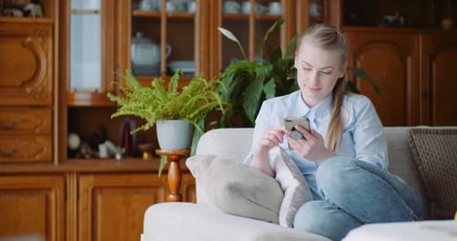 Happy Woman Browsing Smartphone At Home. Businesswoman Working on Smartphone at Home Office.