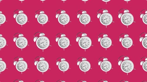 Clocks rotating on pink background