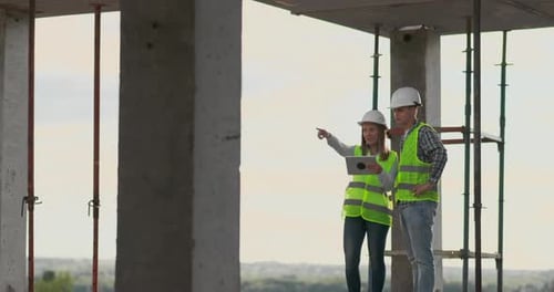 Portrait of Construction Engineers Working on Building Site