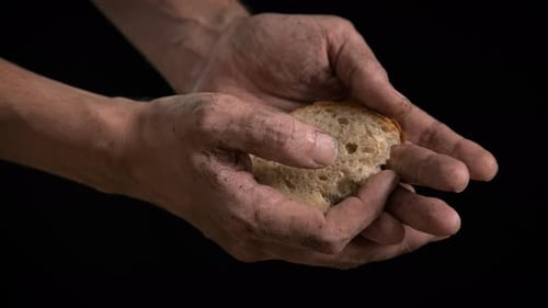 Hungry man with bread.