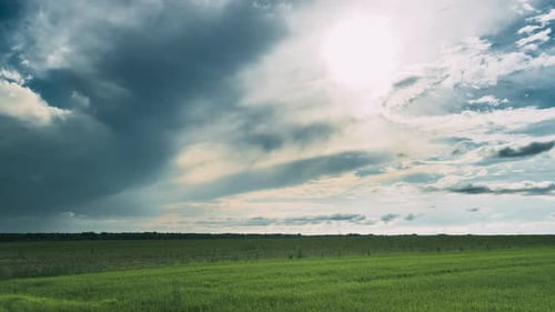 Dramatic Sky Before Rain With Rain Clouds On Horizon Above Rural Landscape Field Meadow