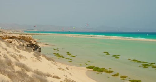 Parachutes in Front of the Blue Sky at Wild White Sand Beach