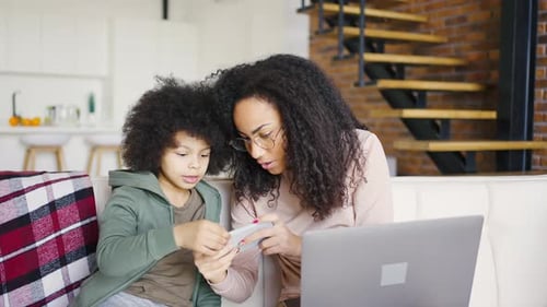 Woman and Child Use Smartphone Together