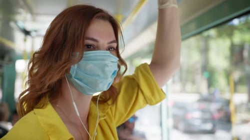 Woman Observes Safety Precautions in Public Place and Wears Medical Mask and Gloves To Protect