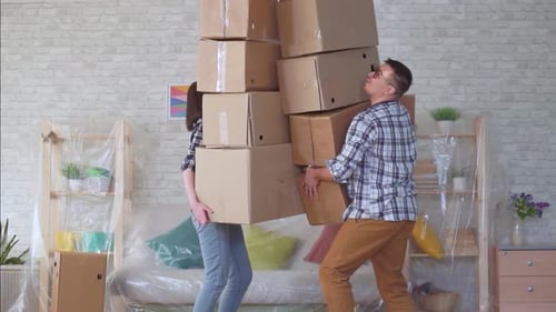 Married Couple with Boxes in Their Hands Clumsily Fall Slow Mo