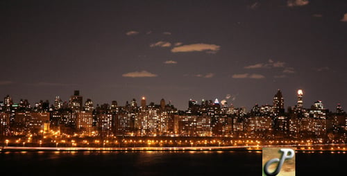 Illuminated Cityscape at Night Reflecting on Water