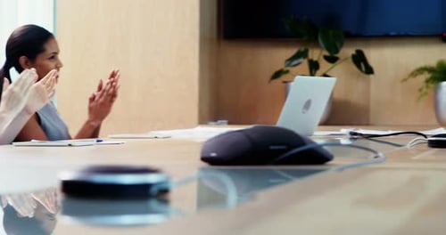 Team Clapping in Corporate Conference Room