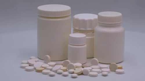 Pills and Medicine Bottles on White Background