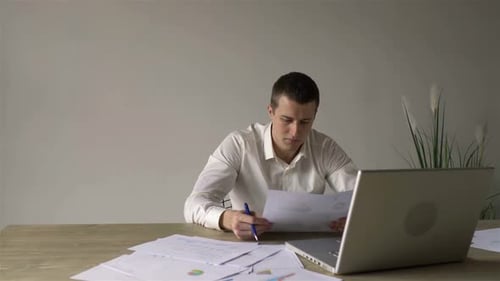 manager with documents at the table in the office