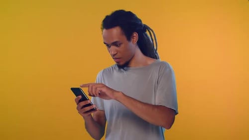 Young Adult Interacting With Smartphone Device