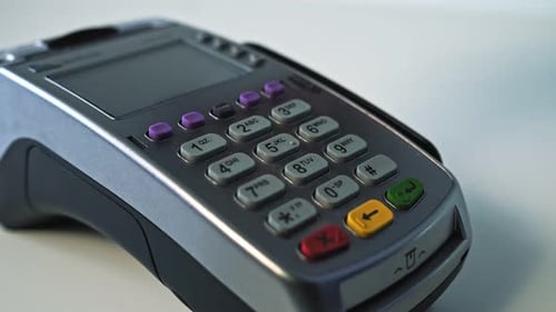 Paying By Credit Card Swiping with Credit Card on Pos Payment Terminal on Table Customer Machine