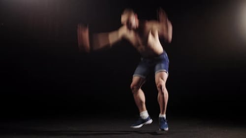 Young Pumped Man Trains His Body in the Arena Warming Up