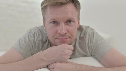 Close Up of Man Looking at The Camera While in Bed
