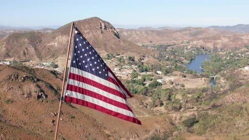 American Flag Waving in Wind on Mountain Top