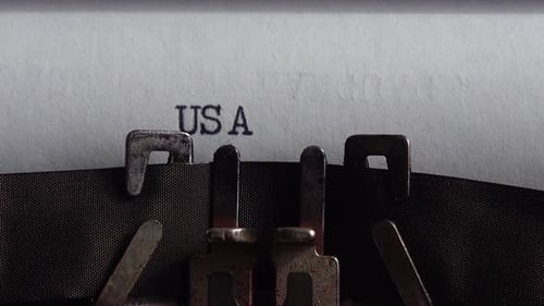 Typing abbreviation USA on a vintage typewriter. Close up.