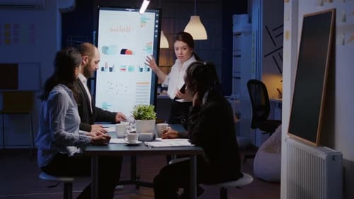 Diverse Team Collaborates on Presentation in Modern Office