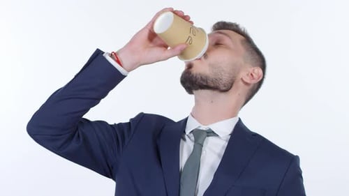 Young Adult Man in Suit Drinks Coffee