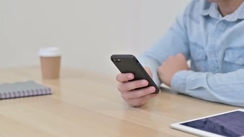 Hand of Man Using Smartphone Close Up