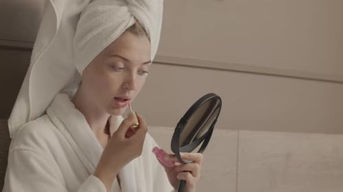 Young Woman Applying Lip Gloss