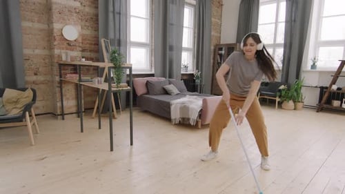 Woman Dances and Mops the Living Room Floor