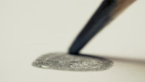 Graphite Pencil Draws a Dot Circle Line on a White Background Paper, Macro Shot