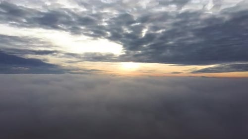 Fly Above the Clouds During Sunrise. Flying Drone Into the Misty Clouds at Evening.