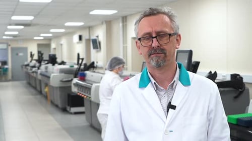 Man in White Coat in Modern Lab Setting