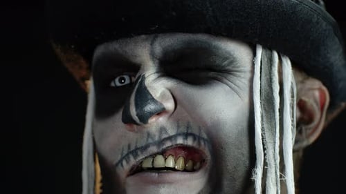Close Up Footage of Sinister Man with Halloween Skeleton Makeup Making Faces, Trying To Scare
