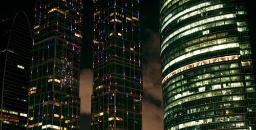 Illuminated Skyscrapers at Night in Urban Landscape