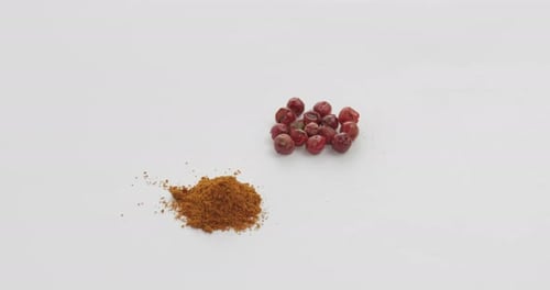 Ground Spice Next to Berries on White Surface