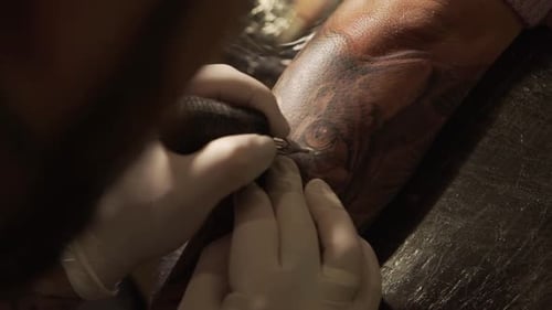 Tattoo Artist Creating Detailed Ink on Forearm