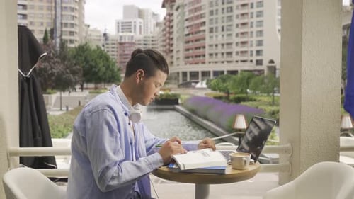 Young Adult Studies at Urban Table with Laptop