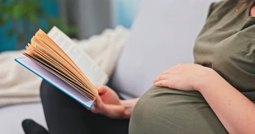 A Woman in Advanced Pregnancy Relaxes on Maternity Leave Spends Her Free Time Reading a