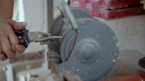 Metal Being Ground on Electric Grinding Machine