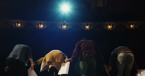Actors Bowing To Audience in a Theater