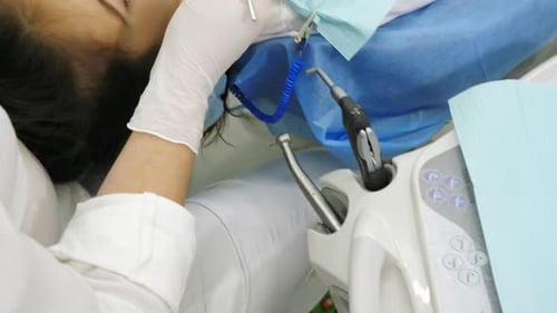 Dentist Examining Child's Teeth in Clinic