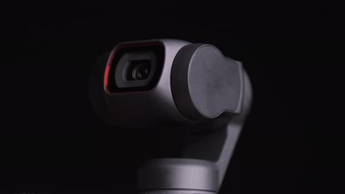 Rotating Camera Lens in Front of Black Backdrop