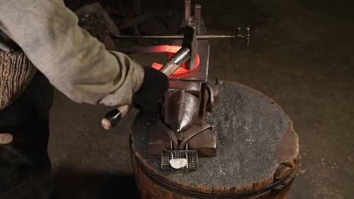 Blacksmith Shaping Red-Hot Horseshoe on Anvil