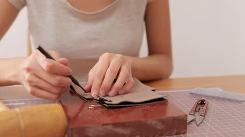 Frau macht Lederhandwerk zu Hause